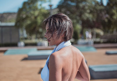 Rear view of man standing in swimming pool