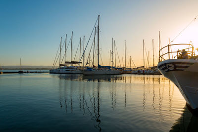 Sailboats in marina at sunset