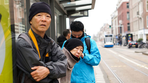 Portrait of friends on street in city