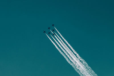 Low angle view of airplane flying against clear sky