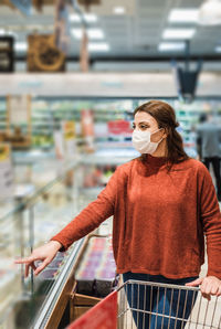 Woman wearing mask shopping at mall