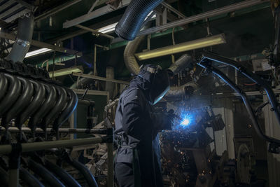 Worker welding at factory