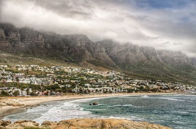 Scenic view of sea and mountains against sky