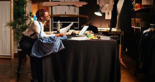 Portrait of woman using mobile phone at home