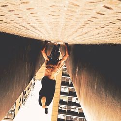 Full length of woman standing on railing