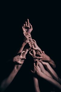 Close-up of human hand against black background