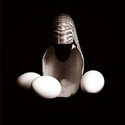 Close-up of light bulb over black background