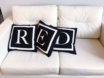 Red text on cushions at home