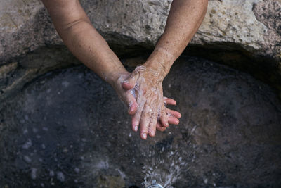 High angle view of person standing on rock