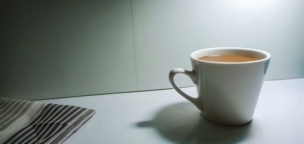 Close-up of coffee cup on table