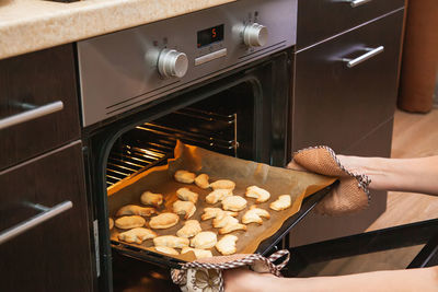 Making cookies for halloween. cut out cookies from dough in the form of pumpkin, cat, ghost and bat.