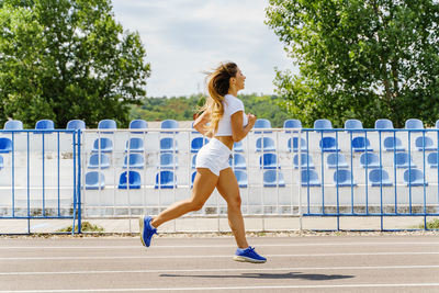 Full length of young woman running