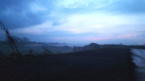 Scenic view of silhouette landscape against sky at dusk