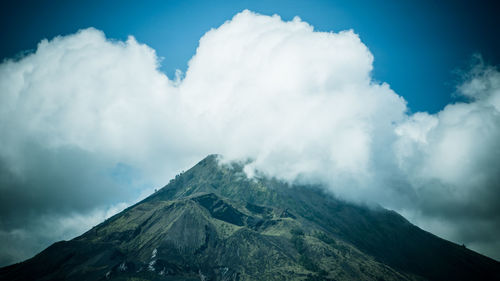 Scenic view of mountains against cloudy sky