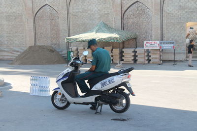 Side view of man riding bicycle on road