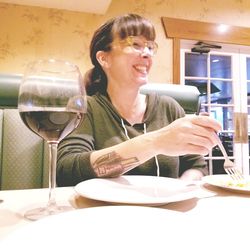 Smiling young woman sitting at restaurant