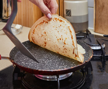 Cropped hand of person preparing food