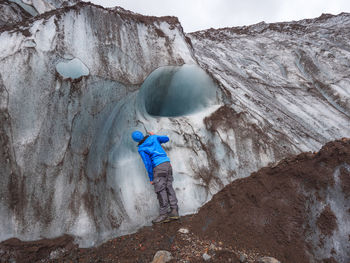 Man standing on rock in snow