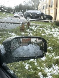 Reflection of car on wet windshield during rainy season