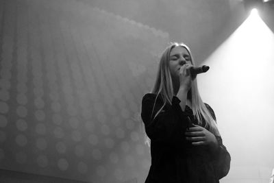 Woman standing against wall