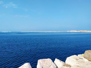 Scenic view of sea against blue sky