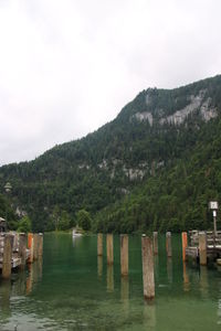 Scenic view of river and mountains against sky