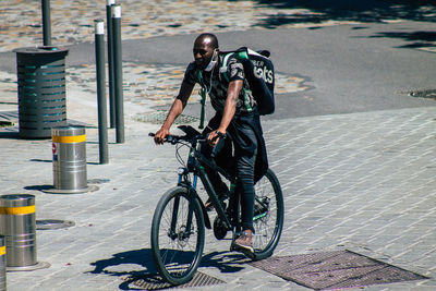 Man riding bicycle on street in city