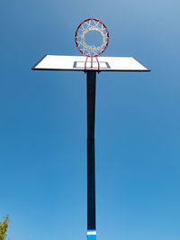 Outdoor basketball hoop in the park, blue sky background