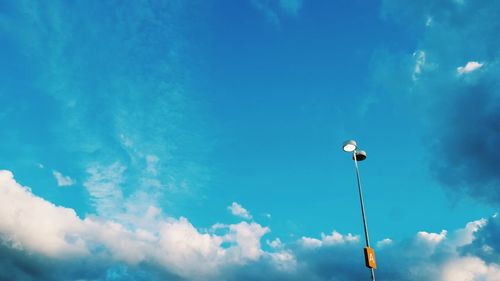 Low angle view of street light against blue sky