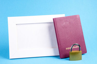 Close-up of open book on table against blue background