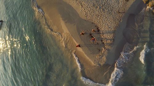 High angle view of friends enjoying at beach