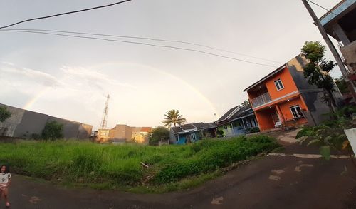 Street amidst houses and buildings against sky
