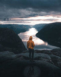 Rear view of man standing on rock preikestolen