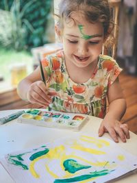 Close-up of girl drawing on table