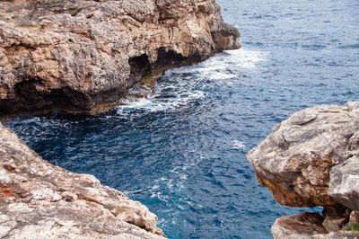 High angle view of rock formation in sea