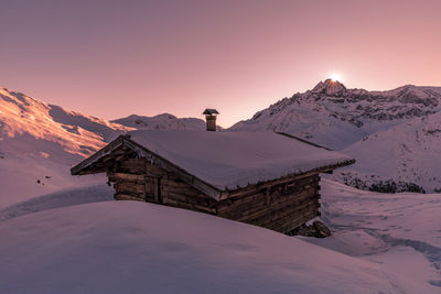 Scenic view of snowcapped mountains against sky during sunset