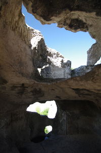 Low angle view of rock formation against sky