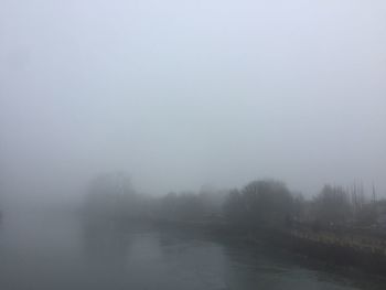 Scenic view of landscape against sky during foggy weather