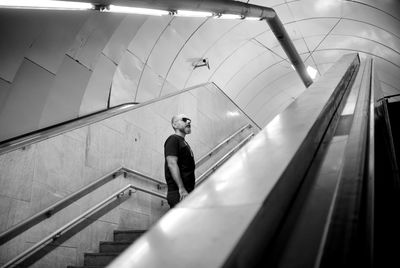 Man standing on steps at subway station