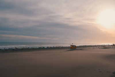 Scenic view of beach against sky during sunset