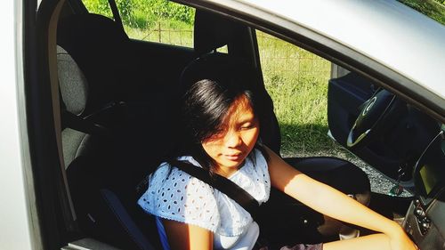 Portrait of woman sitting in car