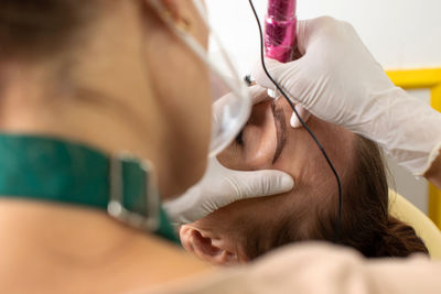 Midsection of doctor examining patient at clinic