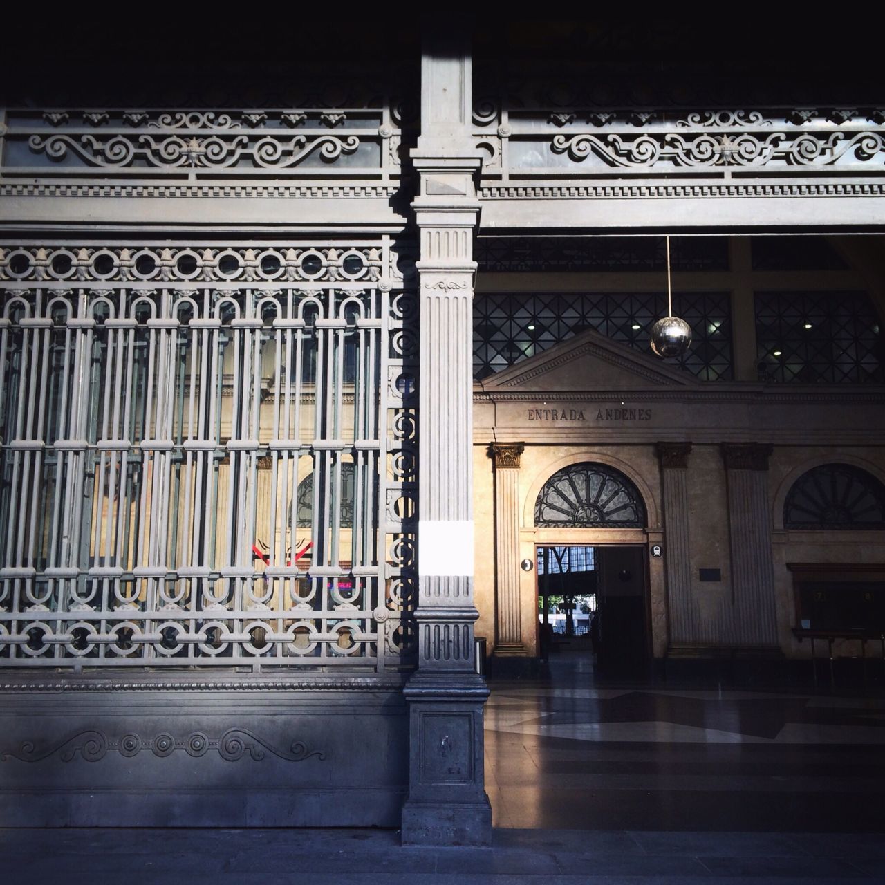 architecture, built structure, text, indoors, western script, non-western script, entrance, door, arch, communication, building exterior, architectural column, low angle view, ornate, history, column, building, art and craft, no people, railroad station