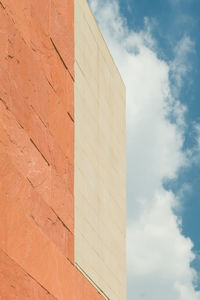 Low angle view of building against cloudy sky