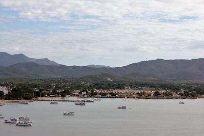 Scenic view of sea and mountains against sky