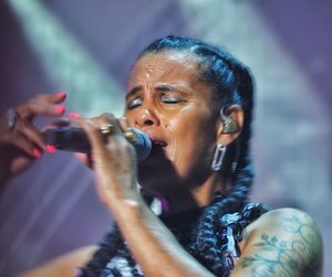 Portrait of woman drinking water from bottle