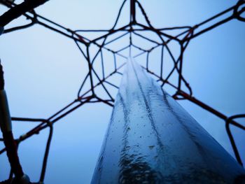 Low angle view of metallic structure against blue sky