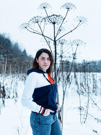 Portrait of woman standing in snow