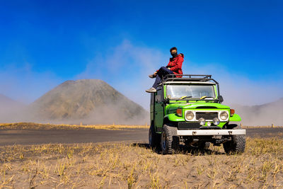 Full length of man sitting on off-road vehicle