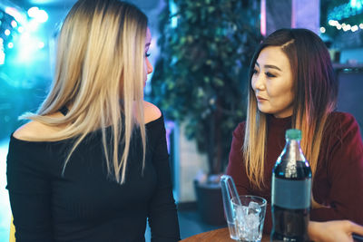 Young woman with drink in restaurant